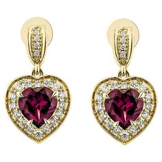 Sunita Nahata showcases an exquisite diamond studded rhodolite earring pair that exudes grace and elegance. This gorgeous 18-karat yellow gold earring pair blends classic elegance with contemporary style, making it perfect for any special occasion. Rhodolite Drop Earrings in 18Karat Yellow Gold with Diamond. Rhodolite: 3.02 carat, 7X7mm size, Heart shape. White Diamond: 0.41 carat, 1.50mm size, round shape, G color, VS clarity. White Diamond: 0.04 carat, 1.10mm size, round shape, G color, VS cla Ethiopian Opal Earrings, Gemstone Drop Earrings, Rainbow Gemstones, Rainbow Earrings, Naha, Gold Earring, Yellow Gold Earring, Opal Earrings, Modern Earrings