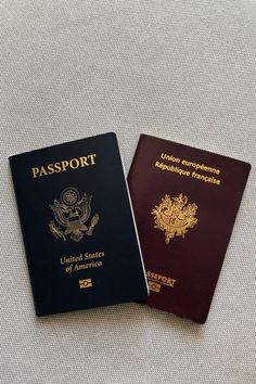 two united states passport sitting next to each other