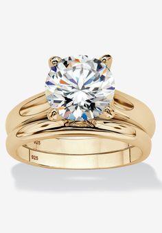 a yellow gold engagement ring set with a round cut diamond in the center and two matching bands