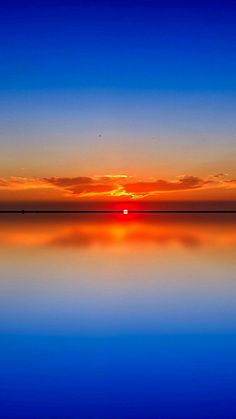 the sun is setting over the water and reflecting it's reflection in the water