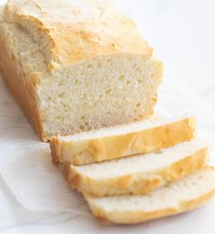 a loaf of white bread sitting on top of a piece of paper