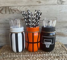 three mason jars filled with different types of straws and black and white striped paper straws