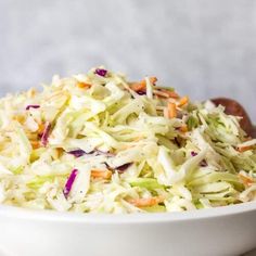 a white bowl filled with coleslaw and carrots