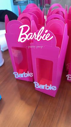 pink barbie party bags on a wooden table