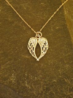 This Angel Wings pendant is 14K Gold. The included chain is a 14K Gold chain. You may chose 16, 18 or 20 inch at the same price. Other length available at sightly higher prices. This Angel Wings pendant measures 13/16" tall by 5/8" across. I hand cast all my pieces using the lost wax casting method. Please ask your needs. You may call me with questions, often I am out so please use my machine. 831-476-3176. You may also call using your credit card directly with me. Satisfaction Guaranteed! I sen Sterling Silver Charm Necklace In Gold, 16 Inch, Silver Heart Pendant Necklace In 14k Gold, 14k Gold Silver Heart Pendant Necklace, Rose Gold Sterling Silver Necklace, Fine Jewelry Sterling Silver Charm Necklace Stamped 14k, Sterling Silver Charm Necklace Stamped 14k, Silver 14k Gold Charm Necklaces For Anniversary, Sterling Silver Pendant Necklace Stamped 14k, Yellow Gold Wing-shaped Necklace For Gift