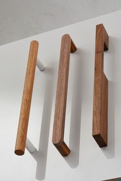 three wooden handles are mounted on the wall