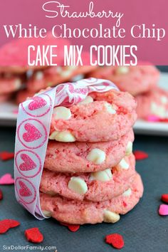 strawberry white chocolate chip cake mix cookies stacked on top of each other with hearts scattered around