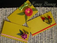 three yellow envelopes with flowers on them