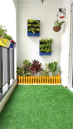 a balcony with artificial grass and potted plants