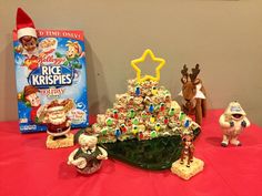 christmas tree made out of cereal krispy kreme's holiday treats and elf figurines