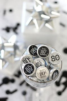 a glass filled with lots of black and white buttons