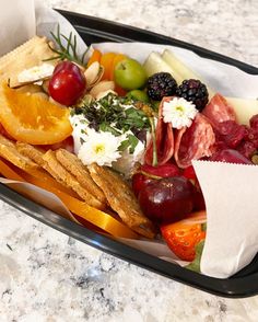 a tray filled with assorted fruits and vegetables