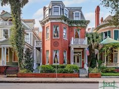 a red brick house with many windows and balconies