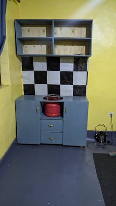 an old fashioned stove in the corner of a room that is painted yellow and blue