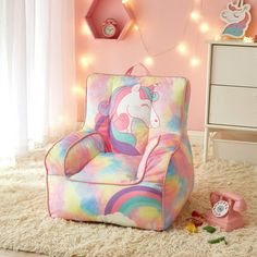 a kid's room with a unicorn chair and lights