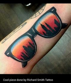 a man's arm with a pair of sunglasses on it