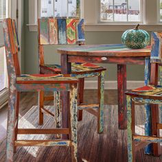 a dining room table with two chairs and a bowl on top of it in front of a window