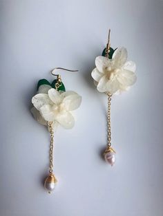 A true piece of art--real cherry blossom/lily flowers preserved in resin and made with 925 sterling silver plated with 14k gold and hanging cute little pearls. A symbol of eternality and elegance. The flowers are hand preserved with resin, and the pattern of the petals are clear and vivid. Each petal is unique and special. **Please avoid direct strong sunshine or hot water. Highlights of this pair of beautiful gold natural floral hanging earrings are: ＊Handmade & Unique Each petal is unique Elegant Wedding Earrings With Birth Flower, Delicate Blossom Earrings For Wedding, Blossom Flower-shaped Earrings For Wedding, Blossom Flower Earrings For Wedding, Blossom Colored Flower Earrings For Wedding, Blossom Colored Jewelry With Matching Earrings For Weddings, Blossom Colored Wedding Jewelry With Matching Earrings, Blossom Wedding Jewelry With Matching Earrings, Elegant Birth Flower Dangle Earrings