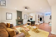 a living room filled with furniture and a fire place next to a wall mounted tv