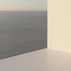 an open window overlooking the ocean on a sunny day with no one in it or someone out there