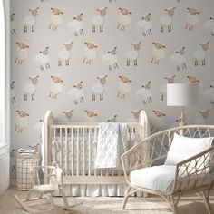 a baby's room with sheep wallpaper and rocking chair in front of the crib