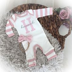 This precious personalized ivory romper with pink striped sleeves and cuffs is perfect for bringing baby home or first photos. It features your baby's initial and name. optional headband is available. Made in ultra soft ribbed cotton.  PLEASE NOTE:  Many of these items contain small parts which could be unsafe for children if left unsupervised.  Please do not leave your child unattended when wearing to prevent any possible choking hazards.  We love your children and want to keep them safe. Personalized Pink Onesie For First Birthday, Pink Cotton Baptism Onesie, Bringing Baby Home, Personalized Baby Girl, Striped Sleeve, Baby Romper, Girls Clothing, First Photo, Love Your