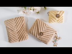 three purses are sitting next to each other on a white surface with flowers in the background