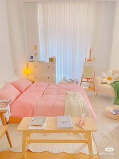 a bed room with a neatly made bed next to a table and chairs in front of a window