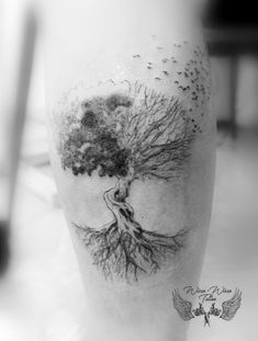 a black and white photo of a tree on the leg