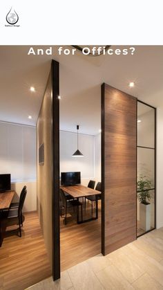 an office with wooden floors and glass partitions to divide the room from the dining area