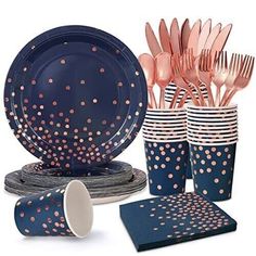 a table setting with pink and blue polka dot paper plates, napkins, cups, and utensils