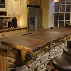 a stone counter top in the middle of a kitchen