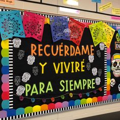 a bulletin board decorated with skulls and flags for dia de los muertos in spanish