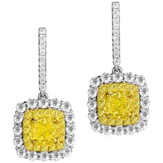 These exquisite earrings feature GIA Certified Oval Cut Natural Fancy Intense Yellow diamonds at the center, measuring 0.86 and 0.79 carats, beautifully encircled by a double halo of round yellow and round white diamonds. They are securely set on lever-back hoops, with additional diamonds elegantly tracing up the front face of the setting. Centers: 0.86 Carat Natural Fancy Intense Yellow VS1; 0.79 Carat Natural Fancy Intense Yellow VVS2 Yellow Halo: 0.42 carats White Halo: 1.09 carats 0.16 carat Yellow Diamond Jewelry, Bling Things, Yellow Diamonds, Front Face, Double Halo, Yellow Earrings, La Face, Pearl Earrings Dangle, Antique Earrings