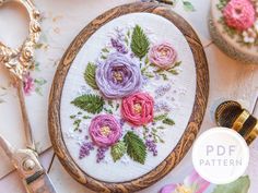 a close up of flowers on a table with scissors and other crafting supplies next to it