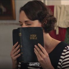 a woman holding a bible in her hands