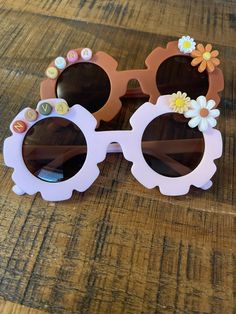 These handmade sunglasses are perfect for baby girls & children of all ages.  Please specify any preferences in the customization box, including child's name. Each pair of sunglasses is made custom-to-order based on your desired style. Cute Sunglasses With Uv Protection For Playtime, Cute Customizable Sunglasses For Beach, Customizable Pink Sunglasses For The Beach, Playful Flower-shaped Plastic Sunglasses, Playful Personalized Sunglasses For Beach, Playful Personalized Sunglasses For The Beach, Personalized Pink Sunglasses For Beach, Personalized Plastic Sunglasses For Beach, Cute Flower Shaped Sunglasses With Uv Protection