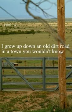 a horse standing in front of a fence with a quote on it's side