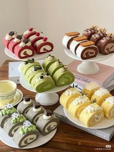 a table topped with different types of pastries and desserts on top of plates