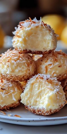 a white plate topped with coconut covered donuts