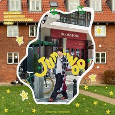 a man walking down a sidewalk next to a tall brick building with stars on it