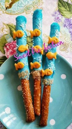 some kind of thing that looks like carrots on a blue plate with white polka dots