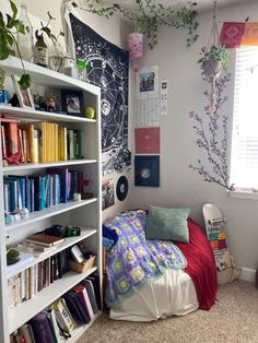 a bedroom with a bed, bookshelf and plants