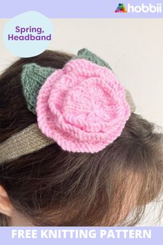 a close up of a child's head wearing a knitted flower hair clip