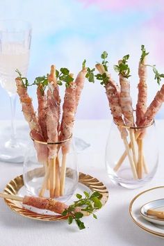 small glass vases filled with food on top of a table