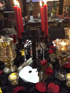 a table topped with candles and other items