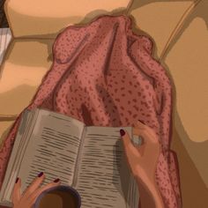 a woman is reading a book on her bed