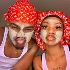 two people with face masks on posing for the camera