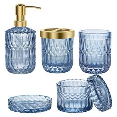 blue glass bathroom accessories including soap dispenser, toothbrush holder and tumbler