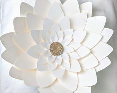 a large white flower with a gold center